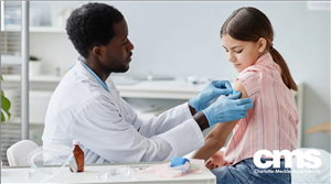 doctor putting bandaid on child